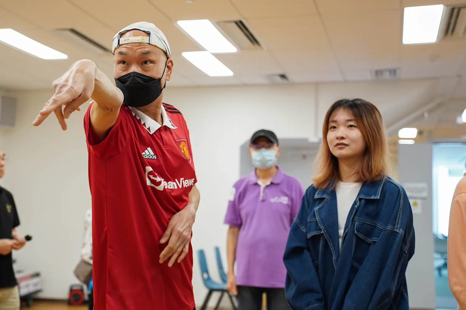 Student volunteers join hands with visually impaired athletes in a darts tournament to promote inclusion