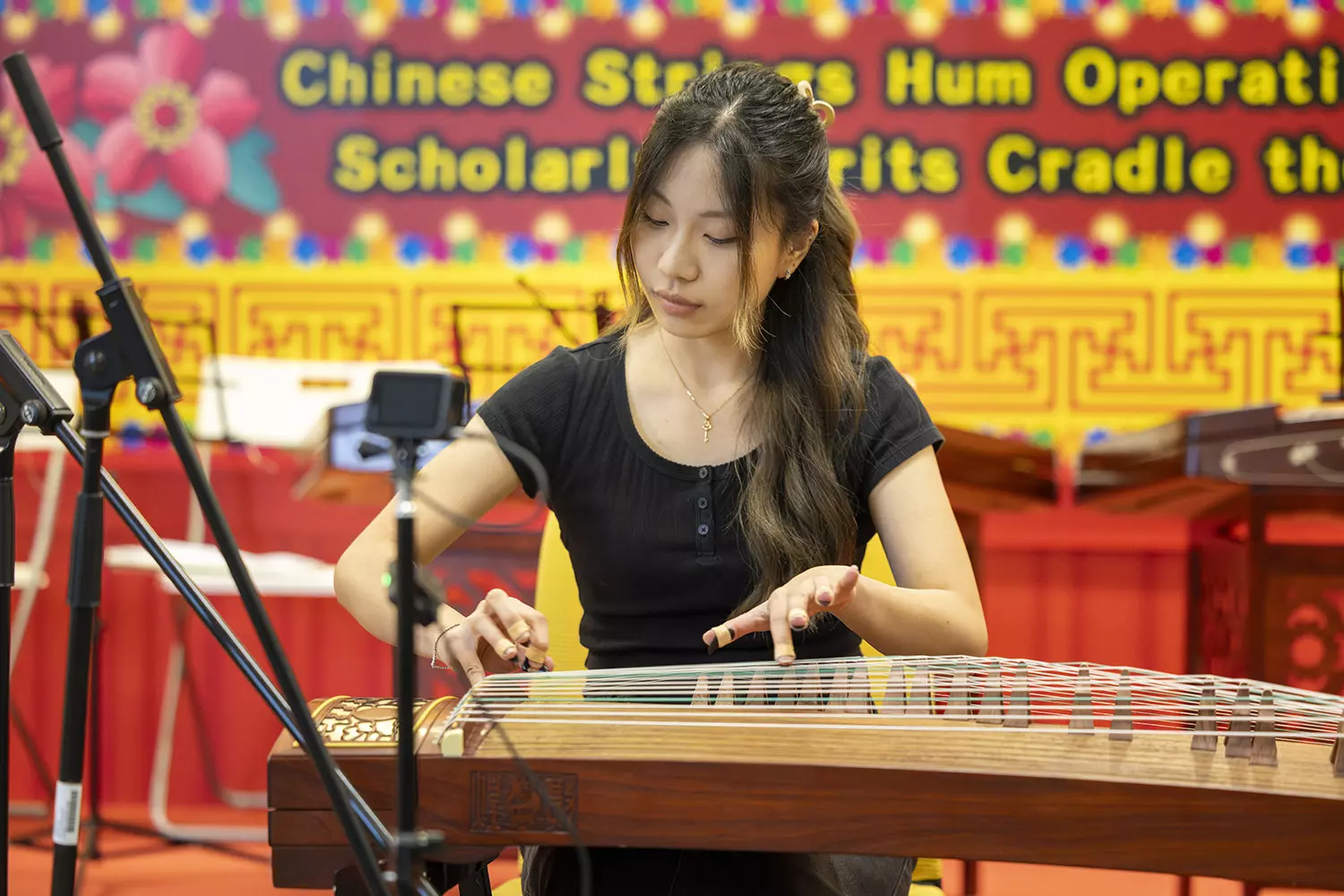 Li Tsz‑ching, a first-year student in Nursing (General Health Care), delivers a guzheng solo performance. 