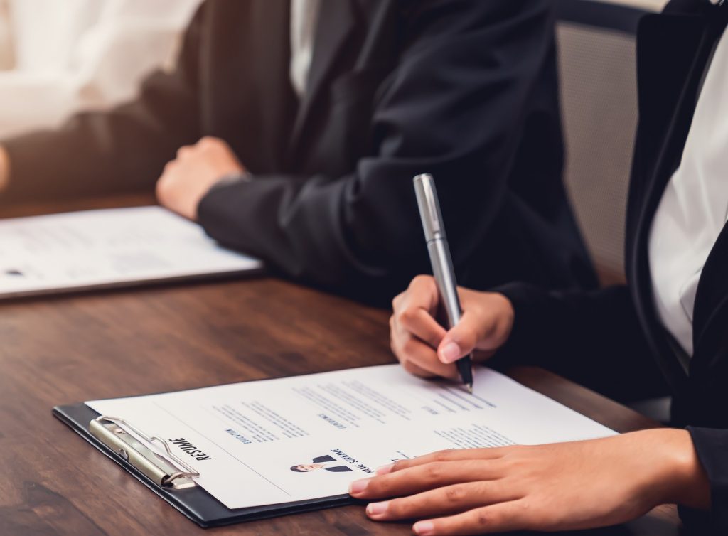 Business people fill resume application information on the desk, presents the ability for the company to agree with the position of the job.
